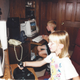An image from WowGrandma78 depicting her grandkids gaming on two PCs she built.